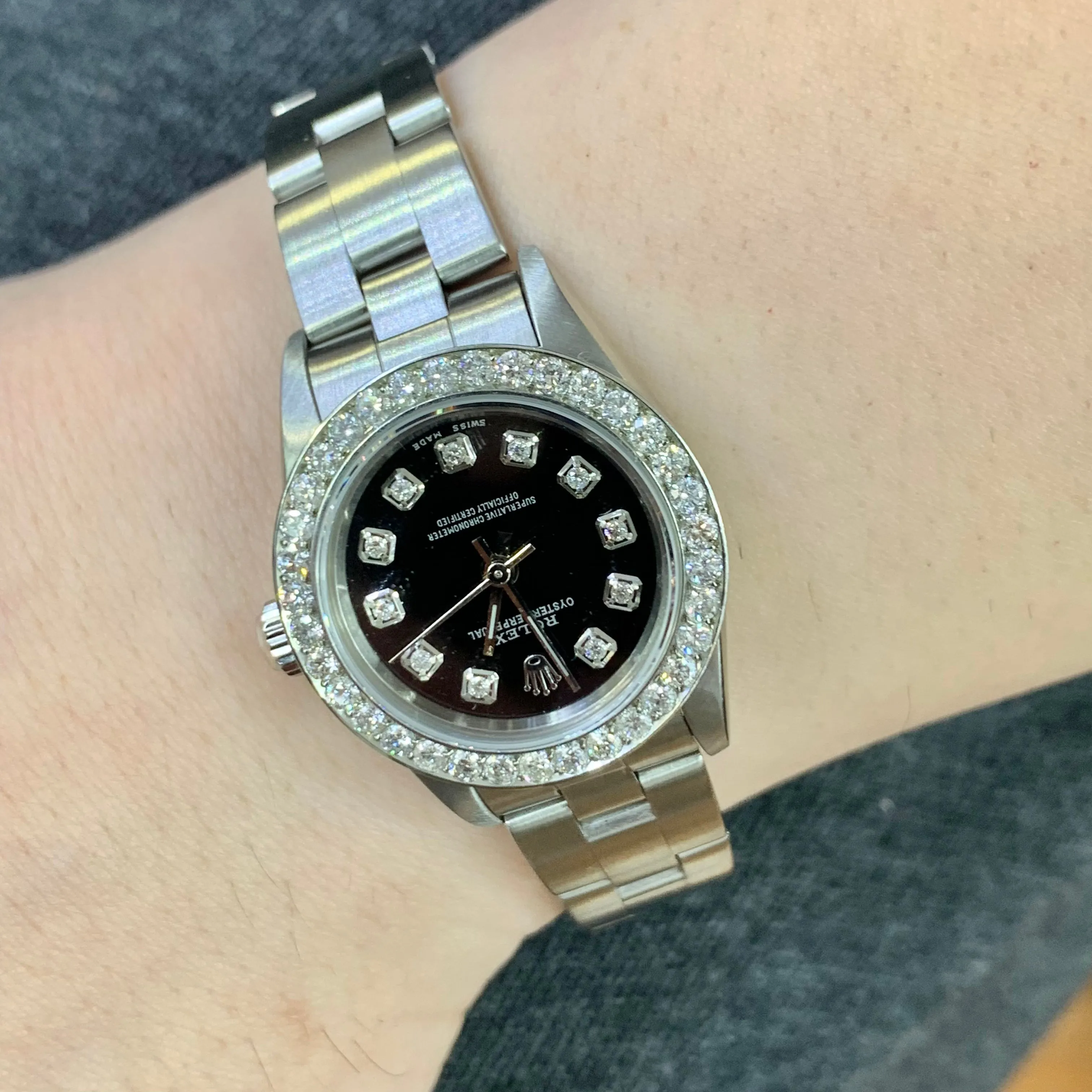24mm Ladies’ Rolex Oyster Perpetual Stainless Steel Diamond Watch (black dial, diamond hour markers)